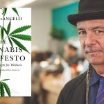 More Than a Manifesto Steve DeAngelo in a black hat and suit beside his book