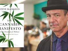 More Than a Manifesto Steve DeAngelo in a black hat and suit beside his book