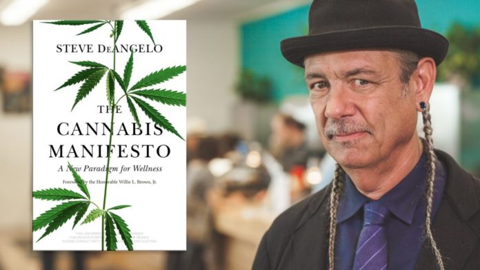 Steve DeAngelo in a black hat and suit beside his book