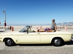 Kenny Morrison: Venice Rising man at beach sitting on yellow convertible