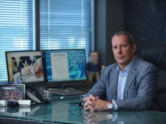 The Kiosk King Is Here To Help business man in suit at executive desk wearing luxury watch