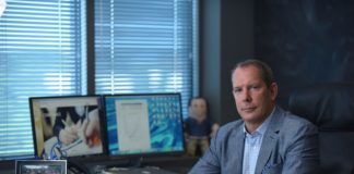 The Kiosk King Is Here To Help business man in suit at executive desk wearing luxury watch