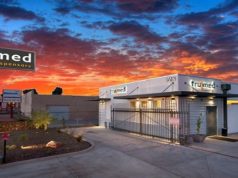 TruMed:Modern, Refined Industrial Chic in the Desert tru med building and parking lot with orange and blue cotton candy sunset