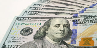 The High Road to Cannabis Payment small fanned out stack of hundred dollar bills focusing on ben franklin