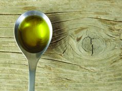 Cannaoil Co. Is Betting Big On Infused Olive Oil cannabis olive oil in silver spoon over wood table