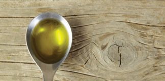 Cannaoil Co. Is Betting Big On Infused Olive Oil cannabis olive oil in silver spoon over wood table