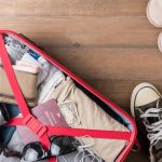 Top Ten 420-Friendly Tourist Destinations red suitcase open with tourist travel essentials