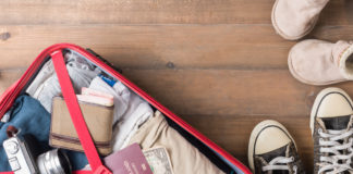 Top Ten 420-Friendly Tourist Destinations red suitcase open with tourist travel essentials