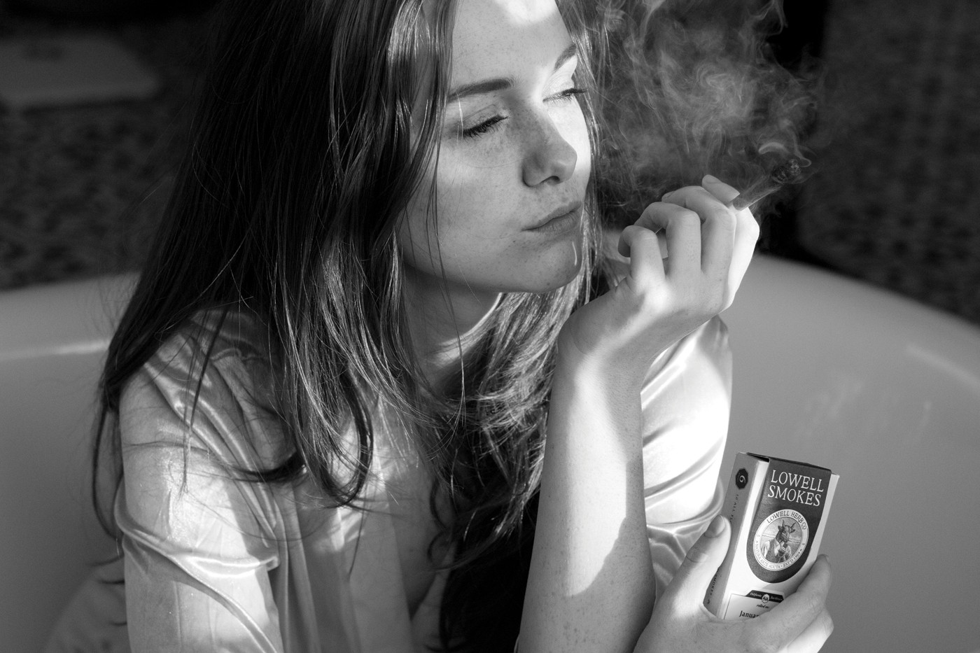 Woman smoking Lowell preroll