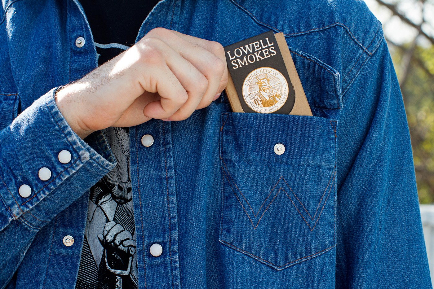 Pack of Lowell Smokes in jean jacket pocket