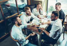 Team Building: Look to Consumer Packaged Goods as an Example Team Working Around Table