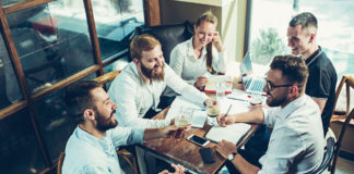 Team Building: Look to Consumer Packaged Goods as an Example Team Working Around Table