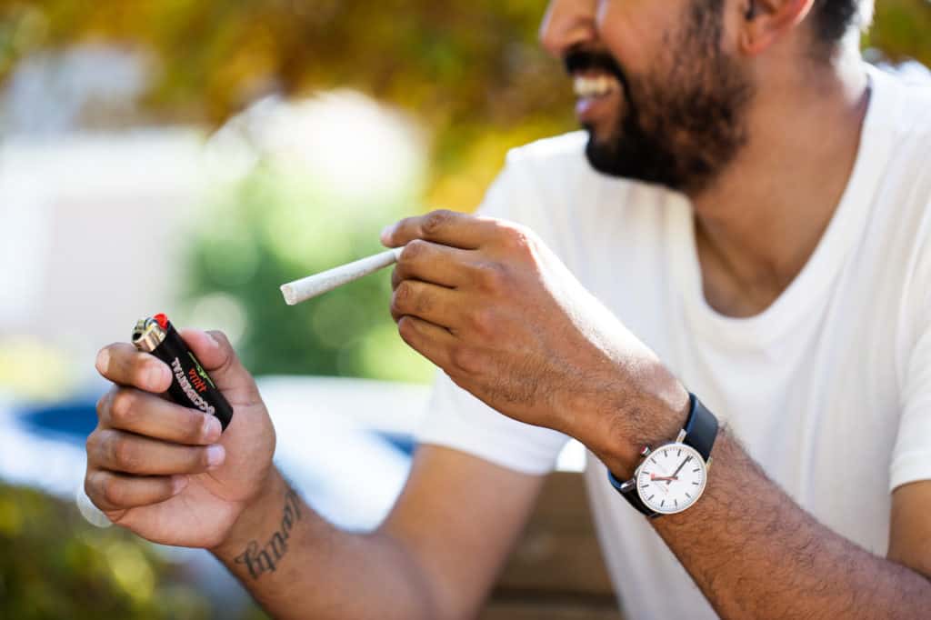 Closeup of guy about to light a joint