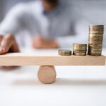 Cannabis Not Suffering Retail Inflation Coins balancing on seesaw inflation Andrey Popov mg Magazine mgretailer