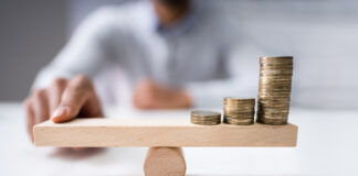 Cannabis Not Suffering Retail Inflation Coins balancing on seesaw inflation Andrey Popov mg Magazine mgretailer