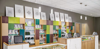 A Closer Look at Visual Merchandising Genius a dispensary counter with light brown and white furniture and splashes of teal and lime green