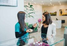 Indica vs Sativa: Unlocking the Antiquated Mystery Dispensary budtender letting a customer smell a cannabis flower product