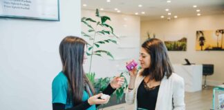 Indica vs Sativa: Unlocking the Antiquated Mystery Dispensary budtender letting a customer smell a cannabis flower product