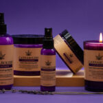Cannabolish Announces A Terpene-Based Solution For A Terpene-Based Problem lavender Cannabolish products purple background with sprays and a candle there is brown wrapping around all the purple product containers