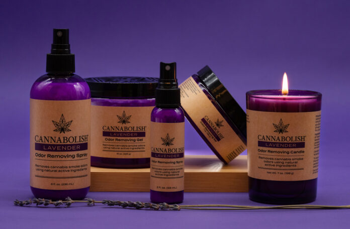 lavender Cannabolish products purple background with sprays and a candle there is brown wrapping around all the purple product containers