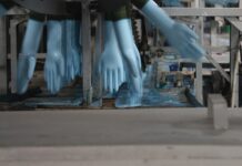 The Truth about Single-Use Gloves blue disposable nitrate gloves running through the production line