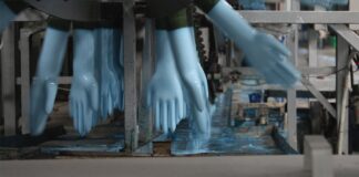 The Truth about Single-Use Gloves blue disposable nitrate gloves running through the production line