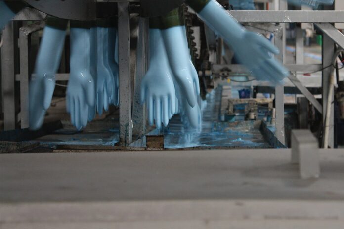 blue disposable nitrate gloves running through the production line