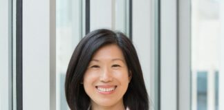 Wana Brands Names Finance and Business Leader Sandy Li Chief Financial Officer a photo of sandy li in a white blazer and a lavender shirt smiling with black shoulder length hair and a big smile