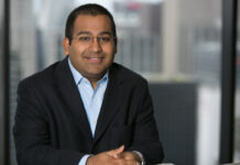 C3 Industries Appoints Valay Shah as Chief Financial Officer professional headshot of a clean shaven man smiling at the camera wearing a black suitcoat and a crisp light blue button up he has black buzzcut hair