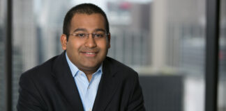 C3 Industries Appoints Valay Shah as Chief Financial Officer professional headshot of a clean shaven man smiling at the camera wearing a black suitcoat and a crisp light blue button up he has black buzzcut hair