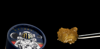 High Life Farms Launches New Line of BHO Extracts in Michigan product image black background lift off extracts container featuring an astronaut on the lid a chunk of golden wax is next to the container