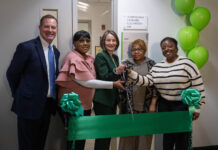 Oakton Community College Formally Dedicates New PharmaCann Cannabis Cultivation Lab a group of people at a ribbon cutting ceremony