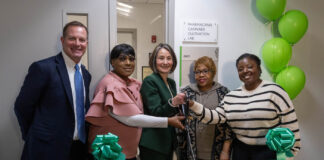 Oakton Community College Formally Dedicates New PharmaCann Cannabis Cultivation Lab a group of people at a ribbon cutting ceremony