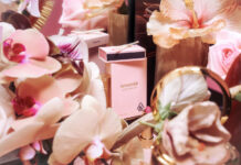 Sundazed Debuts Premium Line of Cannabis Pre Rolls First to Integrate Instagram Filters Into Packaging a light pink preroll box with a matching pack of matches surrounded by pink flowersh