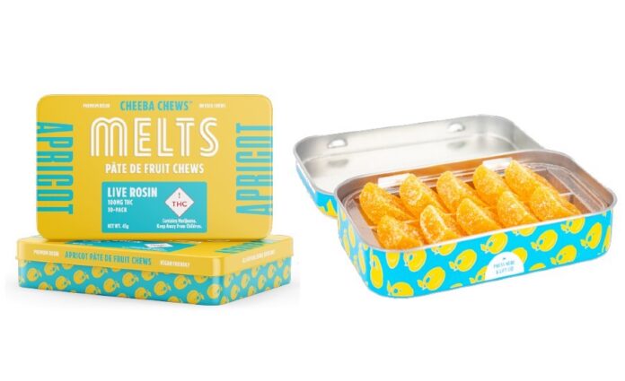Cheeba chews melts display image the rectangular metal container is opened revealing the orange edibles inside and another container is placed next to the open container showcasing the yellow and blue label