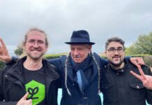 Steve DeAngelo and Andrew DeAngelo Join Harvest Direct’s Advisory Board photo of three men smiling with their arms around one another. The middle man has two long gray braids and is wearing a fedora the man on the left is giving a thumbs up and the man on the right is throwing up a peace sign