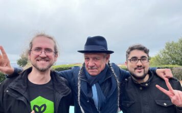 Steve DeAngelo and Andrew DeAngelo Join Harvest Direct’s Advisory Board photo of three men smiling with their arms around one another. The middle man has two long gray braids and is wearing a fedora the man on the left is giving a thumbs up and the man on the right is throwing up a peace sign