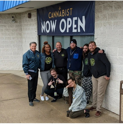 Dispensary workers at The Cannabist in Deptford, NJ celebrate their historic victory in being the first cannabis workers in New Jersey to win an election to unionize they are gathered in a group in front of the Cannabist doors