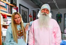 Camp High Launches Brand & Marketing Agency “Camp High Collective” a blonde woman and a man with a big white beard pose for a photo in their leisure sweatsuit line the woman is wearing a light blue sweatsuit and the man is wearing a pink and tie dye sweatsuit