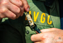Pre-Rolls Get the SpaceX Treatment with Helmand Valley Growers Company’s Chillums close up photo of someone's hands pulling a HVGC product out of a pocket on a jacket with the letters H V G C printed above the pocket