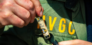 Pre-Rolls Get the SpaceX Treatment with Helmand Valley Growers Company’s Chillums close up photo of someone's hands pulling a HVGC product out of a pocket on a jacket with the letters H V G C printed above the pocket