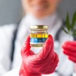 Feds Request New Cultivators to Supply NIDA Researchers cannabis science with CBD oil and red gloves