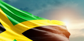 Jamaica: Religion, Culture, and Regulation Jamaica national flag waving in beautiful sky.