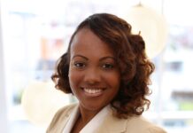Curaleaf Appoints Tyneeha Rivers As Chief People Officer black professional business woman with wavy hair and a tan shirt