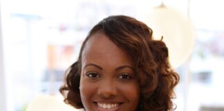 Curaleaf Appoints Tyneeha Rivers As Chief People Officer black professional business woman with wavy hair and a tan shirt