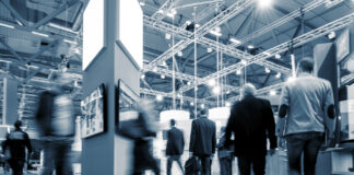 Is the Cannabis B2B Trade Show Model Broken? Can It Be Fixed? group of trade show attendees walking through the show floor
