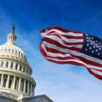 Chuck Schumer’s Federal Legalization Bill Introduced to the Senate American flag waving with the US Capitol Hill in the background