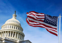 Chuck Schumer’s Federal Legalization Bill Introduced to the Senate American flag waving with the US Capitol Hill in the background