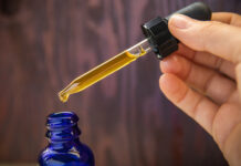 Is Oregon’s CBN Ban Responsible or Regressive Legislation? Concentrated CBD (cannabinoid) cannabis extract oil against wood background