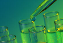 How Fermented Cannabinoids May Disrupt and Support the Industry test-tubes with liquid on blue background